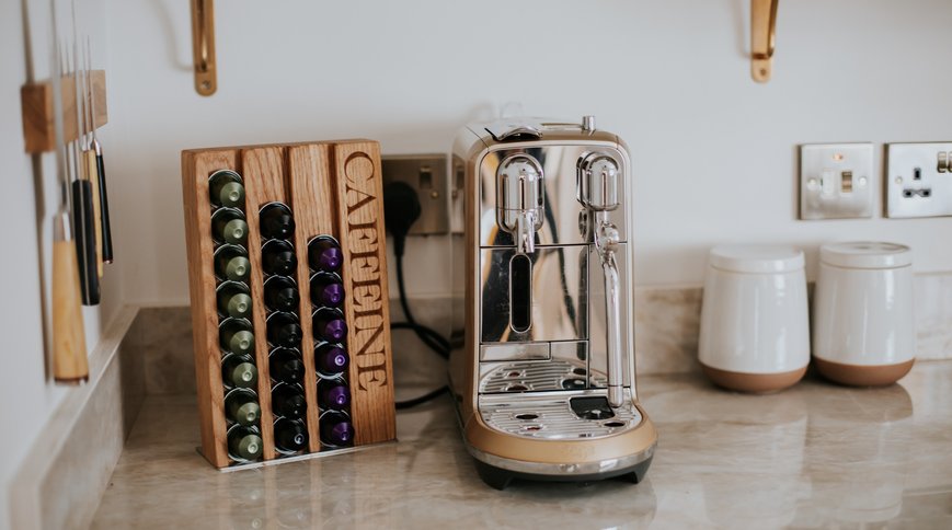 The CAFFEINE coffee pod rack beside the coffee machine. Photo: Charlie & Josie Irons