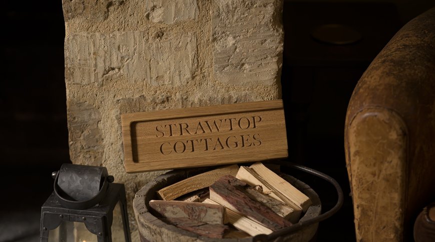 The STRAWTOP COTTAGES jumbo matchbox on the log bucket by the fire. Photo: Sarah Frances Kelley